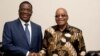 FILE: In this photo supplied by Government Communications and Information Services, (GCIS) former Vice-President of Zimbabwe, Emmerson Mnangagwa, left, shakes hands with South Africa President Jacob Zuma during a short visit, in Pretoria, South Africa.