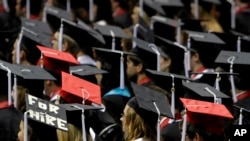 In this Saturday, Aug. 6, 2011 file picture, students attend graduation ceremonies at the University of Alabama in Tuscaloosa, Ala.