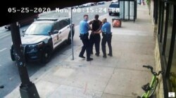 FILE - This image from video shows Minneapolis police Officers Thomas Lane, left and J. Alexander Kueng, right, escorting George Floyd, center, to a police vehicle outside Cup Foods in Minneapolis, on May 25, 2020.