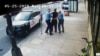 FILE - This image from video shows Minneapolis police Officers Thomas Lane, left and J. Alexander Kueng, right, escorting George Floyd, center, to a police vehicle outside Cup Foods in Minneapolis, on May 25, 2020. 