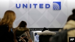 People stand in line at a United Airlines counter at LaGuardia Airport in New York, March 15, 2017. A dog died on a United Airlines plane after a flight attendant ordered its owner to put the animal in the plane's overhead bin.