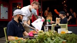 A diner has a lunch outside a restaurant in Didsbury, as the 'Eat Out to Help Out' scheme continues, amid the coronavirus disease (COVID-19) outbreak, in Manchester, Britain, August 10, 2020. REUTERS/Jason Cairnduff