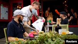 A diner has a lunch outside a restaurant in Didsbury, as the 'Eat Out to Help Out' scheme continues, amid the coronavirus disease (COVID-19) outbreak, in Manchester, Britain, August 10, 2020. REUTERS/Jason Cairnduff
