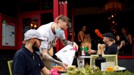 A diner has a lunch outside a restaurant in Didsbury, as the 'Eat Out to Help Out' scheme continues, amid the coronavirus disease (COVID-19) outbreak, in Manchester, Britain, August 10, 2020. REUTERS/Jason Cairnduff