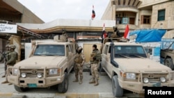 FILE - Members of Iraqi security forces are deployed in Sinjar, Iraq, Dec. 1, 2020.
