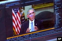 FILE - This image made from video of a fake video featuring former President Barack Obama shows elements of facial mapping used in new technology that lets anyone make videos of real people appearing to say things they've never said.