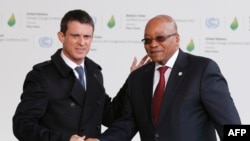 South Africa's President Jacob Zuma (R) is greeted by France's Prime Minister Manuel Valls as he arrives for the COP21 United Nations Climate Change Conference on Nov. 30, 2015 in Le Bourget, outside Paris.