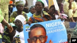 A supporter holds a poster campaigning for former anti-graft chief Nuhu Ribadu during the presidential primaries of ACN in Lagos, 14 Jan 2011