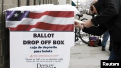A voter participates in early balloting outside the Denver Elections Division in downtown Denver, Colorado on October 25, 2012. 