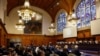 FILE - Delegates attend the U.N.'s International Court of Justice public hearings in an advisory opinion case that may become a reference point in defining countries' legal obligations to fight climate change, in The Hague, Netherlands, Dec. 2 2024. 