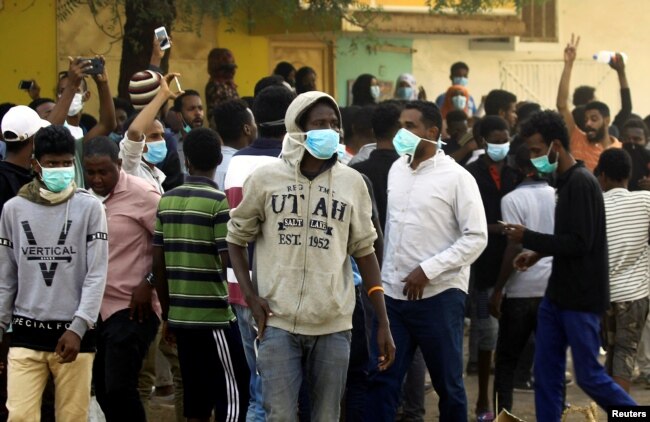 Sudanese demonstrators gather as they participate in anti-government protests in Khartoum, Sudan, Jan. 17, 2019.