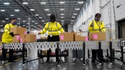 Boxes containing the Moderna COVID-19 vaccine are prepared to be shipped at the McKesson distribution center in Olive Branch, Miss., Sunday, Dec. 20, 2020. (AP Photo/Paul Sancya, Pool)