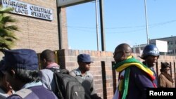 FILE: Zimbabwean Pastor Evan Mawarire (2nd R), who organized a 'stay at home' anti-government protest last week, arrives at the Harare Central Police station in Zimbabwe, July 12, 2016. 