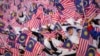 FILE - Students wave national flags during the National Day parade in Putrajaya, Malaysia, Aug. 31, 2024.