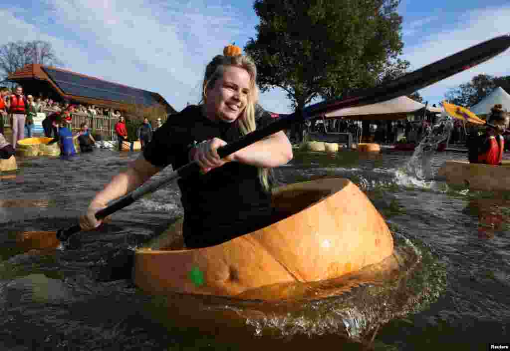 Competitors paddle in giant hollowed out pumpkins at the yearly pumpkin regatta in Kasterlee, Belgium, Oct. 27, 2024.