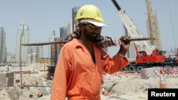 FILE - A worker toils in the heat at a construction site in Dubai, where temperatures can hit 45 degrees C.