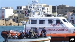 An Italian Coast Guard boat rescues a boat of refugees off Lampedusa, Italy, March 2, 2011