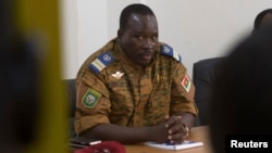 FILE - Lieutenant Colonel Isaac Zida meets with opposition leaders in Ouagadougou, capital of Burkina Faso, Nov. 2, 2014.