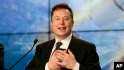 FILE - In this Sunday, Jan. 19, 2020. file photo, Elon Musk founder, CEO, and chief engineer/designer of SpaceX speaks during a news conference after a Falcon 9 SpaceX rocket test flight to demonstrate the capsule's emergency escape system at the…