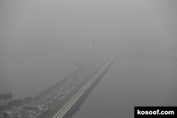 A view of the vehicles plying the causeway to Malaysia shrouded by haze in Singapore September 29, 2015.