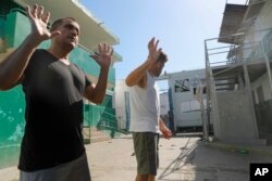 FILE —Colombian inmates accused of participating in the assassination of Haitian President Jovenel Moise talk to journalists inside the National Penitentiary in Port-au-Prince, Haiti, March 3, 2024.