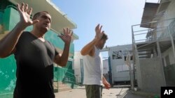 FILE—Colombian inmates accused of participating in the assassination of Haitian President Jovenel Moise talk to journalists inside the National Penitentiary in Port-au-Prince, Haiti, Sunday, March 3, 2024.