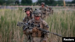 U.S. soldiers from 5-20 infantry Regiment attached to 82nd Airborne walk while on patrol in Zharay district in Kandahar province, southern Afghanistan, April 24, 2012.