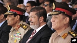 Presiden Mesir Mohammed Morsi (tengah) didampingi Marsekal Hussein Tantawi (kiri) dan Panglima Angkatan Darat Mesir, Sami Anan menghadiri sebuah parade militer (foto: dok). 