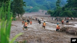 Rescue workers search for the missing after a flash flood buries a hamlet in mud and debris in the aftermath of Typhoon Yagi in Lao Cai province, Vietnam, Sept. 12, 2024. 