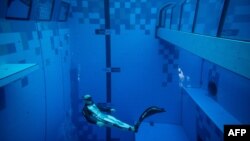 FILE: In a representative example of "free diving" (no SCUBA tank), a diver is seen in the deepest pool in the world with 45.5-meter depth. Located in Mszczonow about 50 km from Warsaw, Poland. Taken Nov. 21, 2020.