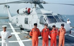 FILE - Four Taiwanese naval pilots posed for a group portrait in front of a U.S.-made S-70 C anti-submarine helicopter onboard the Chengkong, a Taiwanese frigate which docked in Penghu naval base, Aug. 20, 1999.