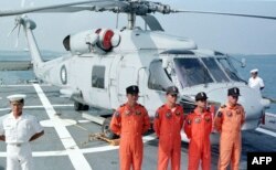 FILE - Four Taiwanese naval pilots posed for a group portrait in front of a U.S.-made S-70 C anti-submarine helicopter onboard the Chengkong, a Taiwanese frigate which docked in Penghu naval base, Aug. 20, 1999.