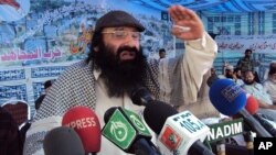 FILE - Syed Salahuddin, Supreme commander of Hizbul Mujahideen whose militants are fighting in Indian Kashmir against the Indian army, addresses his supporters in Muzaffarabad capital of Pakistan's administered Kashmir, July 13, 2011. 