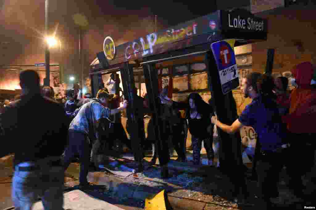 Protesters destroy the Lake Street bus stop outside the Minneapolis Police third precinct during the third day of demonstrations in response to the death of African-American man George Floyd in Minneapolis, Minnesota, U.S. May 28, 2020. REUTERS/Nicholas Pfosi