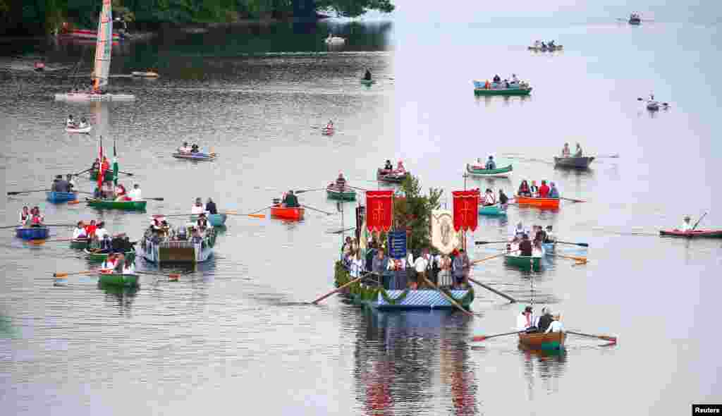 Bavarian inhabitants of Seehausen, wearing traditional clothes, take part in a Corpus Christi procession over the lake Staffelsee near Murnau, Germany.