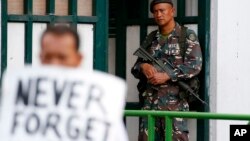 A soldier watches demonstrators protest President Rodrigo Duterte's Martial Law declaration for the southern Mindanao region, July 7, 2017 in Manila, Philippines. 