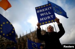 An anti-Brexit protester demonstrates outside the Houses of Parliament in London, Britain, March 12, 2019.