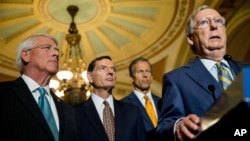 Majority Leader Mitch McConnell, backed by, from left, fellow Republican Senators Roger Wicker, John Barrasso and John Thune, speaks on Capitol Hill, where he later called passage of the USA Freedom Act a victory for U.S. enemies, June 2, 2015.