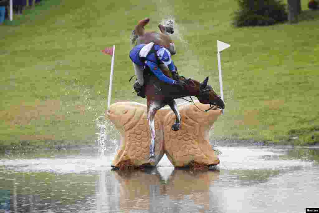 Mikhail Nastenko of Russia riding Reistag falls at the Lochan fence in the cross country event of FEI European Eventing Championship at Blair Castle, Scotland, Britain, Sept. 12, 2015.