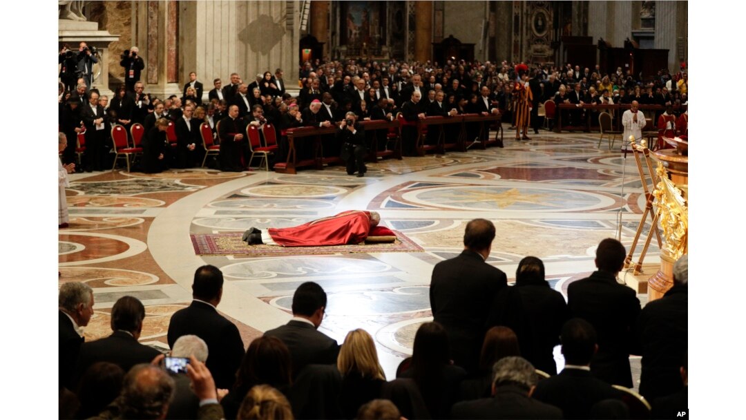 Pope Francis prostrates himself in prayer during the Good Friday Passion of Christ Mass inside St. Peter's Basilica, at the Vatican, March 30, 2018.