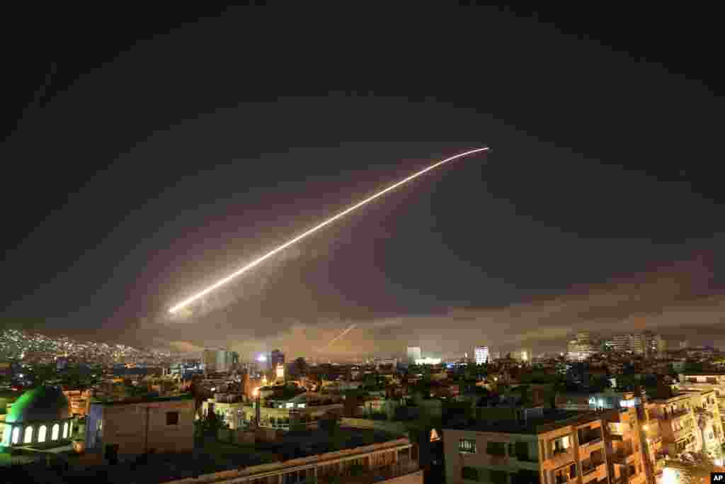 Missile fire lights up the Damascus sky, April 14, 2018.