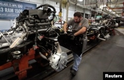 Chrysler assembly staff works on the chassis of a 2014 Dodge Ram pickup truck at the Warren Assembly Plant in Warren, Michigan December 11, 2013. Chrysler Group LLC, which is owned by Fiat SpA, on January 29, 2014, said its revenue would rise 11 percent t