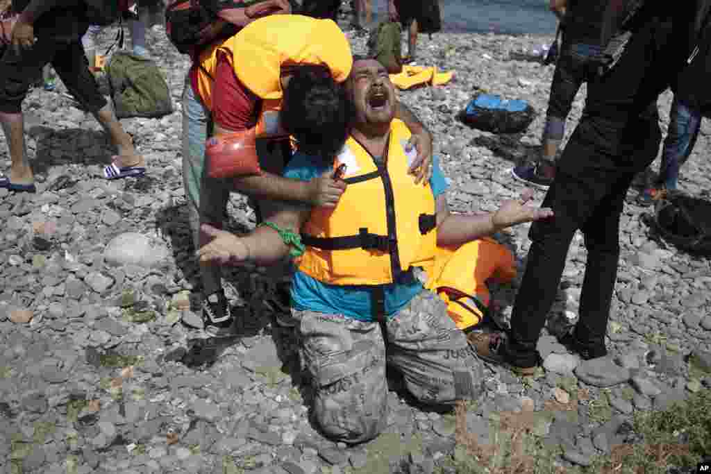 Syrian refugees react as they arrive on the island of Lesbos, Greece, after crossing aboard a dinghy from Turkey. 