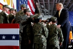 FILE - U.S. President Donald Trump greets troops after speaking at a Memorial Day event aboard the USS Wasp on May 28, 2019, in Yokosuka, Japan.