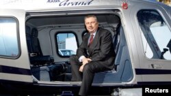 FILE - Finmeccanica Chairman and Chief Executive Officer Giuseppe Orsi poses in a helicopter during the opening ceremony of the new Terminal of Vertiporto dell'Urbe in Rome on January 19, 2009. 