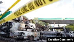 A gas station is seen burned down after disturbances following the police shooting of a man in Milwaukee, Wisconsin, Aug. 14, 2016. 