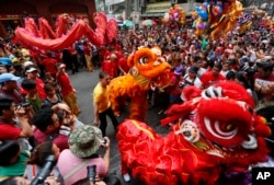 Dragon and lion dancers perform before a huge crowd in celebration of the Chinese Lunar New Year, Feb. 8, 2016 at Manila's Chinatpwn district in Manila, Philippines.