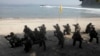 FILE - U.S. Marines from the 3rd Marine Expeditionary Brigade and the 31st Marine Expeditionary Unit and Philippine marines take their positions as they take part in a boat raid exercise during their joint military exercise, dubbed PHIBLEX 2016.