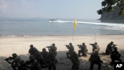U.S. Marines from the 3rd Marine Expeditionary Brigade and the 31st Marine Expeditionary Unit and Philippine marines take their positions as they take part in a boat raid exercise during their joint military exercise, dubbed PHIBLEX 2016.