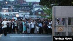 문재인 대통령 부인 김정숙(가운데 흰 상의) 여사가 26일 '열린 청와대 50년 만의 한밤 산책' 행사에서 시민들과 함께 반세기만에 열리는 문을 바라보고 있다.